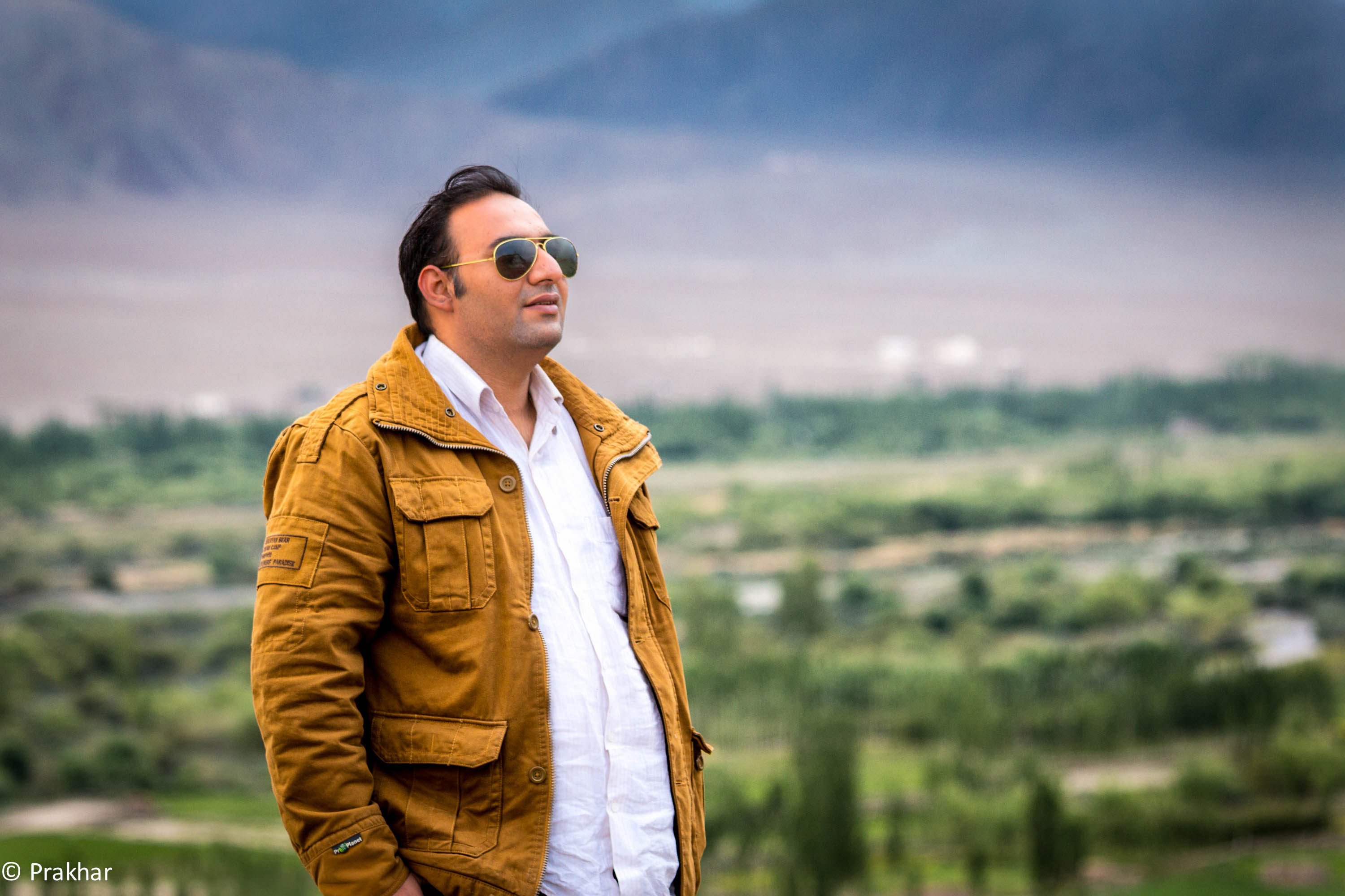 Prakhar in Leh, Ladakh — mustard jacket against the valley